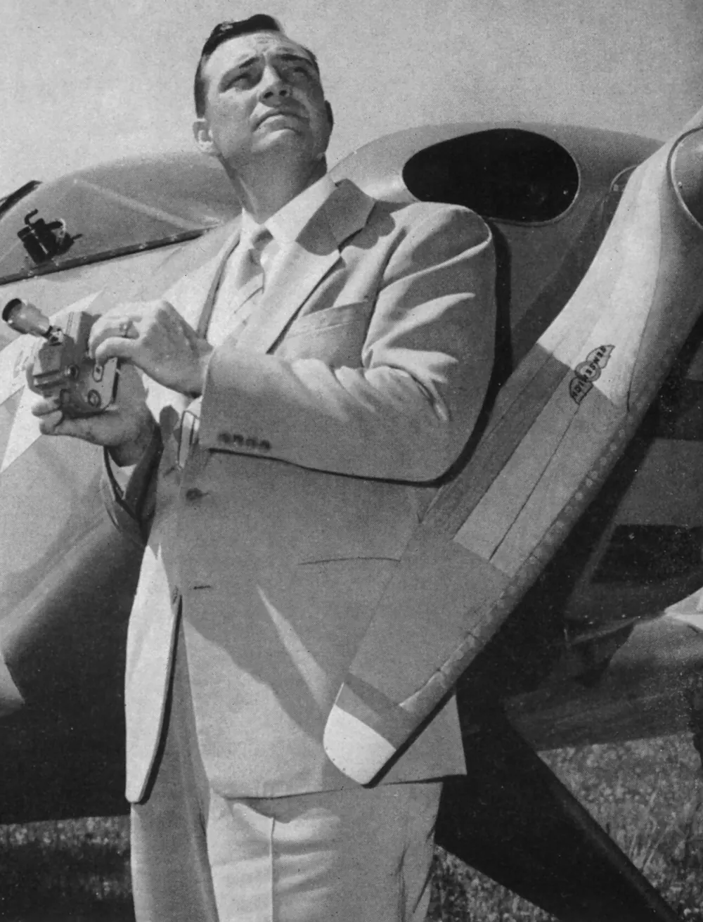 Kenneth Arnold standing by his airplane